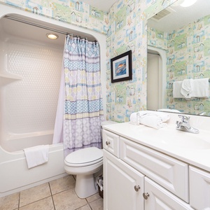 Refresh in this guest bathroom, featuring a lighted shower area and ample counter space for your essentials