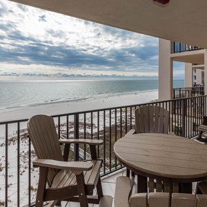 Savor the view from the balcony, featuring comfortable seating and a table perfect for enjoying your morning coffee