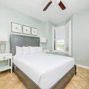 This cozy guest bedroom features a stylish headboard, soft bedding, and a charming bay window for a relaxing retreat
