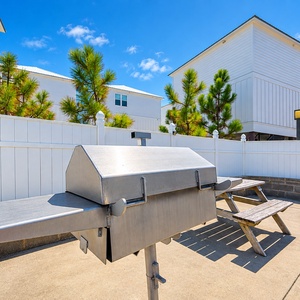 Gather around the picnic table for a fun barbecue experience with grills and a cozy space for family and friends