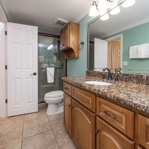 Refresh in this stylish guest bathroom featuring a spacious vanity, elegant fixtures, and a walk-in shower