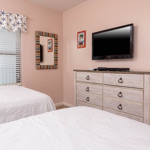 Rest in this cheerful guest room with two double beds, a flat-screen TV, and beach-themed decor for a relaxing getaway