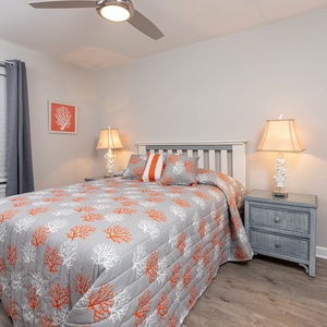 Rest peacefully in this charming guest bedroom featuring a cozy queen bed and soft lighting