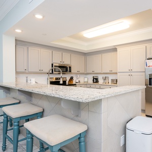 Prepare meals in this kitchen with elegant cabinetry, stainless appliances, and spacious countertops