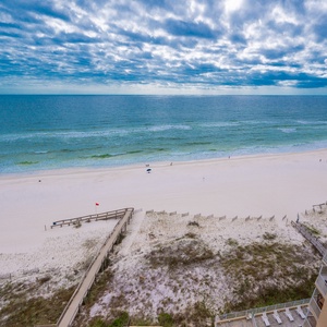 Experience breathtaking views of the sandy shore and tranquil waters from your private balcony, perfect for relaxation