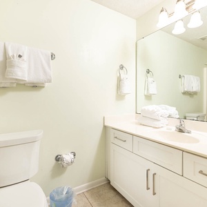 Refresh in the guest bathroom featuring a spacious vanity, ample towels, and a bright, welcoming atmosphere
