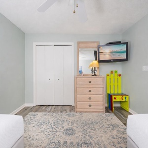 In this guest suite with two twins, playful colors and coastal art brighten your restful retreat