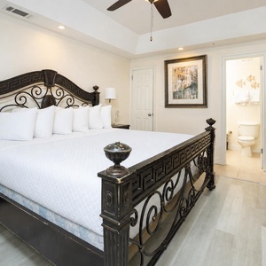 Experience restful nights in this elegant guest bedroom featuring a king bed, decorative pillows, and stylish artwork