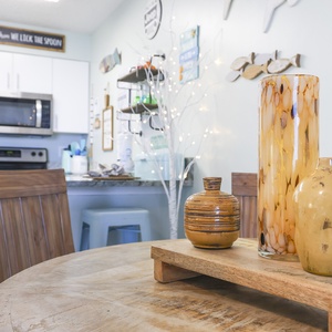 The dining area features decorative accents for a cheerful dining or gathering experience