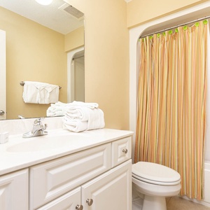 Refresh and rejuvenate in this guest bath, surrounded by soft towels and inviting decor after beach adventures