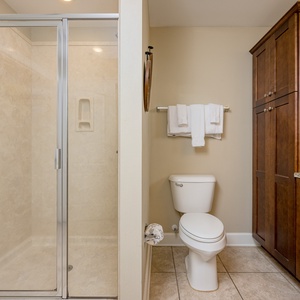 Refresh in the stylish guest bath featuring a walk-in shower, elegant cabinetry, and decorative nautical accents