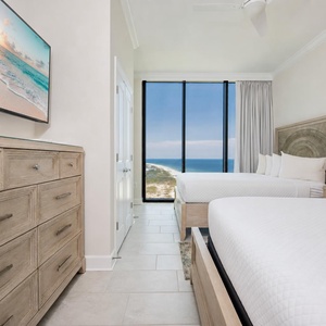 Dual queen guest room inviting you to relax with coastline views and peaceful sleep