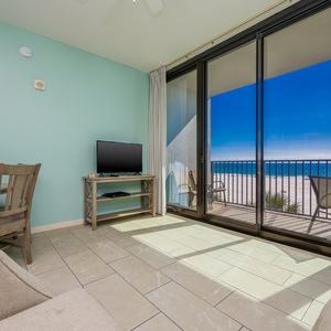 Enjoy the inviting living area with a comfortable sofa, dining space, and expansive views through large sliding doors