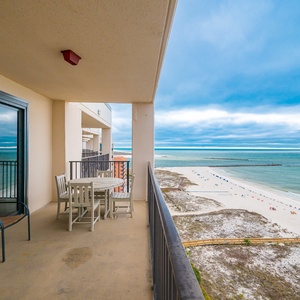Relax on your balcony with a table for conversation, soaking in the stunning coastal views and tranquil vibes around you