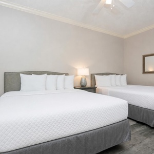 Drift into peaceful slumber on one of the double beds with a soothing vibe in this inviting guest room