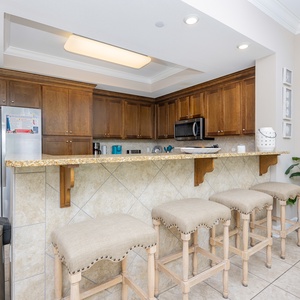 Sip your morning coffee at the breakfast bar and get ready for a beach day in this stylish space
