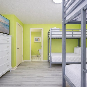Cozy up with the family in this cheerful twin over full bunk room, perfect for movie nights on the large TV