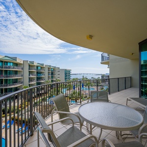 Enjoy coffee on the spacious balcony, taking in serene views of the bay and pool area