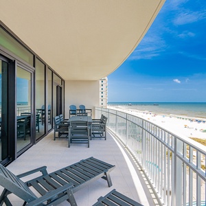 Relax on the spacious balcony with comfortable seating, perfect for enjoying the refreshing coastal breeze