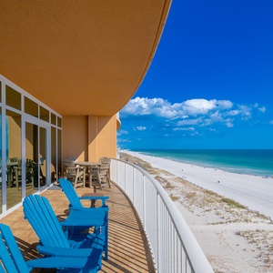 Relax on your beachfront balcony enjoying expansive views of the tranquil waters and inviting coastal vibe