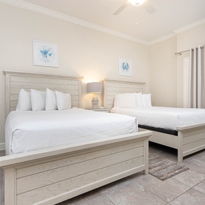 Rest in this queen guest suite, where plush bedding and serene decor create a peaceful retreat after beach days