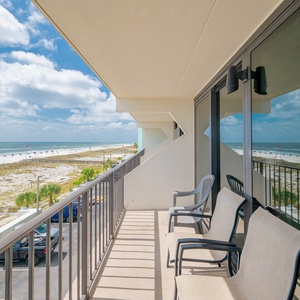 Enjoy the serene beachfront view from the balcony, complete with comfortable seating and a refreshing atmosphere