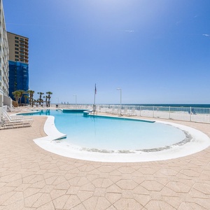 Relax by the beachfront pool with stunning views and easy access to the sandy shore just steps away