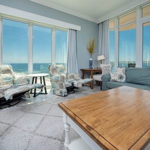 Admire the beachfront gulf through the wall of floor-to-ceiling windows, perfect for a relaxing beach vacation