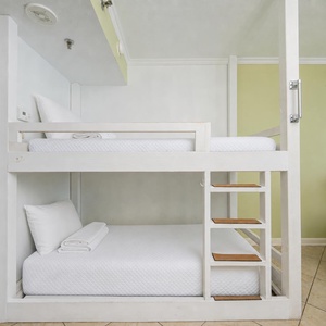 Bunk area with white linens offers a restful spot for kids or teens during your beach getaway
