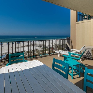 Enjoy the turquoise chairs and table on the balcony, perfect for soaking in the breathtaking beach views