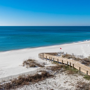Stroll along the boardwalk leading to the beach, where you can enjoy sun-soaked days and gentle waves