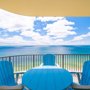 Enjoy tranquil moments on your balcony, sitting back in vibrant chairs while admiring endless coastal views