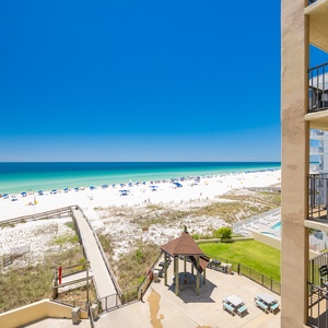 A boardwalk leads you from the resort to the coast where the turquoise water meets the sky