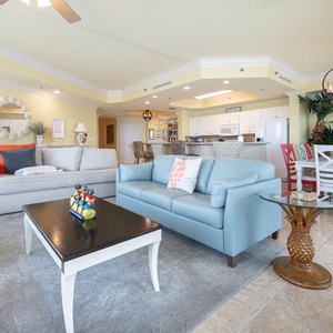 Relax in the inviting living area featuring a sofa with queen sleeper, a stylish coffee table, and views of the open kitchen