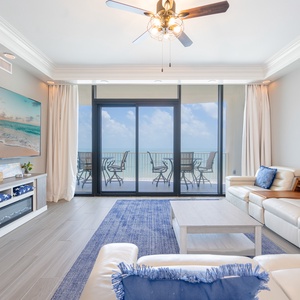 Relax in this spacious living area with entertainment, a fireplace, and coastal decor