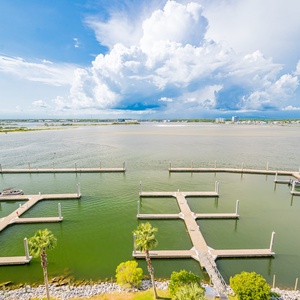 View of tranquil waters and scenic docks under a vibrant sky, perfect for a relaxing getaway