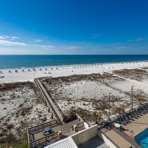 This inviting view showcases a beachfront scene with a sparkling pool and lounge area, perfect for relaxation and fun