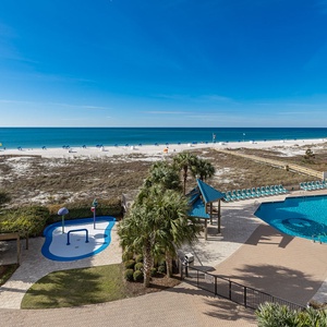 Breathe in the coastal vibes while lounging by the pool, surrounded by lush palms and serene beach views