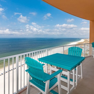 Relax on turquoise chairs at the balcony table, feeling gulf breezes while watching the beachfront below