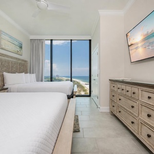Inviting guest room with two queens and breathtaking coastline views awaiting your arrival