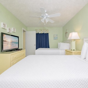 Two double beds in this guest suite welcome you to unwind while streaming your favorite show