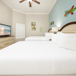 Drift into comfort on the plush queen beds while enjoying your favorite shows on the TV in this cheerful retreat