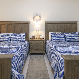 Slide under the covers, switch on the lamp, and enjoy coastal starfish art for a restful retreat