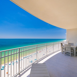 Relax on the spacious balcony with comfortable seating, enjoying expansive views of the tranquil waters below