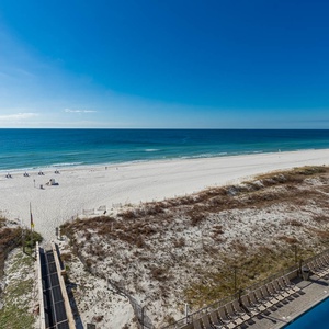 Relax by the pool while enjoying expansive views of the tranquil waters and inviting beach area just steps away