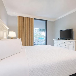 Unwind after a fun vacation day and stream your favorite shows in the king master suite with balcony access