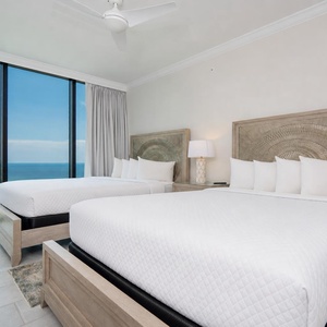 Enjoy a peaceful stay in this charming guest room with two queens and stunning beach views