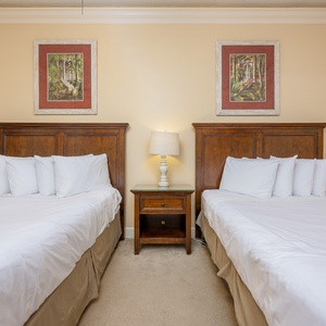 Bask in restful slumber on the queen beds as calming decor surrounds this serene guest retreat for cozy nights