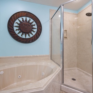Master bath jetted tub and separate walk-in shower, enhanced by cheerful sun-themed decor