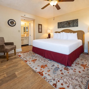The master bedroom features a plush king bed, stylish decor, and a convenient en-suite bathroom for a relaxing stay